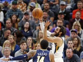 Utah Jazz guard Ricky Rubio, right, passes the ball as Denver Nuggets guard Gary Harris (14) defends during the first half of an NBA basketball game Wednesday, Oct. 18, 2017, in Salt Lake City. (AP Photo/Rick Bowmer)