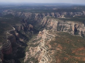 FILE - This May 8, 2017, file photo shows an aerial view of Arch Canyon within Bears Ears National Monument in Utah. President Donald Trump is shrinking two national monuments in Utah, Bears Ears and Grand Staircase Escalante, accepting the recommendation of Interior Secretary Ryan Zinke to reverse protections established by two Democratic presidents, a Sen. Orrin Hatch, R-Utah, said Friday, Oct. 27.  (Francisco Kjolseth/The Salt Lake Tribune via AP, File)