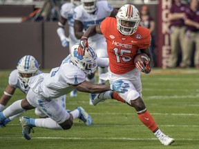 Virginia Tech wide receiver Sean Savoy (15) gains yardage against North Carolina safety Myles Dorn (1) during the first half of an NCAA college football game, Saturday, Oct. 21, 2017, at Lane Stadium in Blacksburg, Va. (AP Photo/Don Petersen)