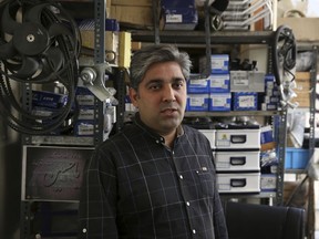Mehdi Shakeri an importer of car parts speaks during an interview with The Associated Press at his shop in downtown Tehran, Iran, Monday, Oct. 9, 2017. As U.S. President Donald Trump threatens the Iran nuclear deal, those living in Tehran feel that an accord they have yet to benefit from may already be doomed, hardening their skepticism about America. Trump is set to deliver a speech on Iran this week in which he is expected to decline to certify Iran's compliance in the landmark 2015 agreement. (AP Photo/Vahid Salemi)