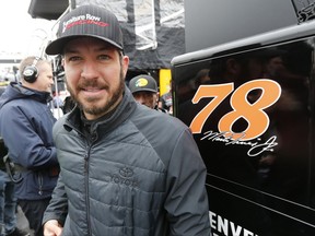 Martin Truex Jr. heads to the hauler after qualifying for the NASCAR Cup series auto race at the Martinsville Speedway in Martinsville, Va., Sunday, Oct. 29, 2017. Truex finished second and will start on the outside of the front row. (AP Photo/Steve Helber)