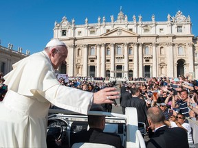 Pope Francis waves from his pope-mobile as he is driven through the crowd ahead of his weekly general audience, in St. Peter's Square, at the Vatican, Wednesday, Oct. 4, 2017.  (L'Osservatore Romano/Pool Photo via AP)