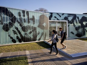 In this Friday, Oct. 6, 2017 photo, a man and woman walk by an installation created by Brazilian artist Regina Silveira as part of the South American biennale or Bienalsur, at Memory Park in Buenos Aires, Argentina. Bienalsur, now based in Buenos Aires, seeks to break the mold by bringing contemporary art to new audiences and allowing artists to experiment freely. (AP Photo/Victor R. Caivano)