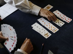 FILE - In this Sept. 22, 2015 file photo, competitors play bridge at the Acol Bridge Club in West Hampstead, London. The European Union's top court ruled Thursday, Oct. 26, 2017 that when it comes to taxes the game of bridge a is not a sport. (AP Photo/Tim Ireland, File)