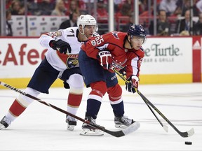 Washington Capitals left wing Andre Burakovsky (65), of Austria, skates with the puck in front of Florida Panthers right wing Radim Vrbata, back, of the Czech Republic, during the second period of an NHL hockey game, Saturday, Oct. 21, 2017, in Washington. (AP Photo/Nick Wass)