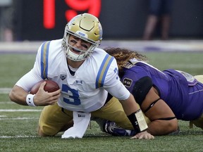 UCLA quarterback Josh Rosen (3) is sacked by Washington's Benning Potoa'e late in the first half of an NCAA college football game Saturday, Oct. 28, 2017, in Seattle. (AP Photo/Elaine Thompson)