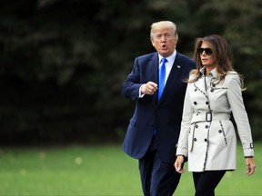 President Donald Trump and first lady Melania Trump walk on the South Lawn of the White House in Washington, Friday, Oct. 13, 2017, to board the Marine One to visit the United States Secret Service James J. Rowley Training Center in Beltsville, Md. (AP Photo/Manuel Balce Ceneta)