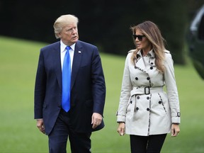 President Donald Trump and first lady Melania Trump walk on the South Lawn of the White House in Washington, Friday, Oct. 13, 2017, upon arrival from a visit to the United States Secret Service James J. Rowley Training Center in Beltsville, Md. (AP Photo/Manuel Balce Ceneta)