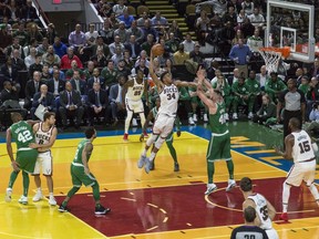 Milwaukee Bucks' Giannis Antetokounmpo leaps for a dunk but is fouled by Boston Celtics' Aron Baynes during the first half of an NBA basketball game Thursday, Oct. 26, 2017, in Milwaukee. (AP Photo/Tom Lynn)