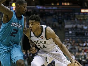 Milwaukee Bucks' Giannis Antetokounmpo drives on Charlotte Hornets' Marvin Williams during the second half of an NBA basketball game, Monday, Oct. 23, 2017, in Milwaukee. (AP Photo/Tom Lynn)