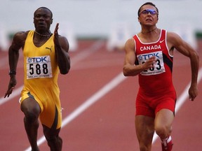 In this Aug. 25, 2003 file photo, Canadian sprinter Nicolas Macrozonaris (right) competes against Ghana's Eric Nkansah in the men's 100-metre semifinals at the world athletics championships in Paris.