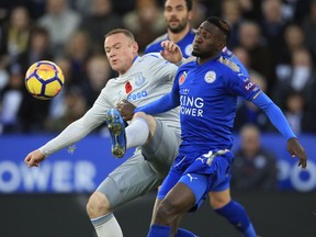 Leicester City's Wilfred Ndidi, right, and Everton's Wayne Rooney battle for the ball during their English Premier League soccer match at the King Power Stadium in Leicester, England, Sunday Oct. 29, 2017. (Mike Egerton/PA via AP)