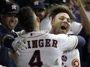 Houston Astros' Yuli Gurriel is congratulated by George Springer after hitting a home run during the second inning of Game 3 of the World Series against the Los Angeles Dodgers on Friday, Oct. 27, 2017, in Houston.