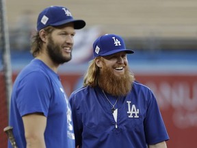 Los Angeles Dodgers starting pitcher Clayton Kershaw, left, and third baseman Justin Turner watch during batting practice for baseball's World Series against the Houston Astros, Monday, Oct. 23, 2017, in Los Angeles. (AP Photo/David J. Phillip)