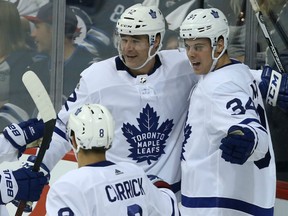 Toronto Maple Leafs forward Patrick Marleau, centre, celebrates his goal against the Jets with Auston Matthews and Connor Carrick during their game Wednesday night in Winnipeg.