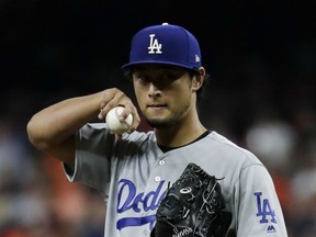 Los Angeles Dodgers starting pitcher Yu Darvish, of Japan, reacts after giving up an RBI against the Houston Astros during the second inning of Game 3 of baseball's World Series Friday, Oct. 27, 2017, in Houston. (AP Photo/Matt Slocum)