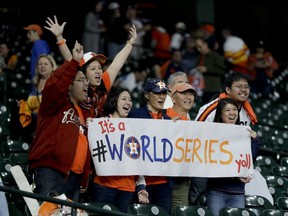 Houston Astros fans celebrate after there win against the Los Angeles Dodgers during Game 3 of baseball's World Series Friday, Oct. 27, 2017, in Houston. The Astros won 5-3 to take a 2-1 lead in the series. (AP Photo/Charlie Riedel)