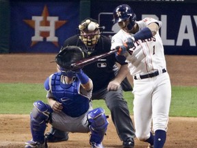 Houston Astros' Carlos Correa hits a two-run home run off Los Angeles Dodgers relief pitcher Brandon Morrow during the seventh inning of Game 5 of baseball's World Series Sunday, Oct. 29, 2017, in Houston. (AP Photo/Charlie Riedel)