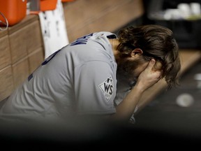 Los Angeles Dodgers starting pitcher Clayton Kershaw sits in the dugout after Houston Astros' Yuli Gurriel hit a three-run home run during the fourth inning of Game 5 of baseball's World Series Sunday, Oct. 29, 2017, in Houston. (AP Photo/Matt Slocum)