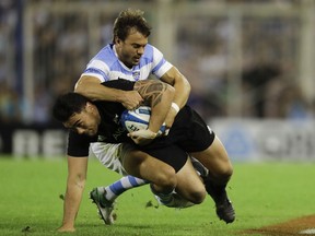 In this Saturday, Sept. 30, 2017 photo, New Zealand's All Blacks hooker Codie Taylor, below, is tackled by Argentina's Los Pumas fly-half Juan Martin Hernandez during a rugby Championship match in Buenos Aires, Argentina. (AP Photo/Natacha Pisarenko)