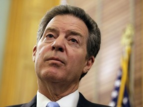 FILE - In this July 27, 2017, file photo, Kansas Gov. Sam Brownback talks to the media during a news conference in Topeka, Kan. The Republican-led Senate Foreign Relations Committee narrowly approved the nomination of Kansas Gov. Sam Brownback to be U.S. ambassador-at-large for international religious freedom on Thursday, Oct. 26. (AP Photo/Charlie Riedel, File)