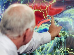 FILE - In this Oct. 19, 2005 file photo, Max Mayfield, the former director of the hurricane center (now retired), draws a line showing one of the possible trajectories of Hurricane Wilma in Miami. It's not just this year. The monster hurricanes Harvey, Irma, Maria, Jose and now Lee that have raged across the Atlantic are contributing to what appears to be the most active period for major storms on record.   AP Photo/Alan Diaz)