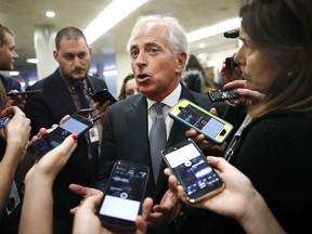 Sen. Bob Corker, R-Tenn., speaks to reporters while heading to vote on budget amendments, Thursday, Oct. 19, 2017, in Washington.  U.S. sanctions against Iran automatically would kick in if Tehran violates new constraints, according to a draft Republican bill crafted by GOP Sens. Bob Corker of Tennessee and Tom Cotton of Arkansas and sought by President Donald Trump as he tries to unravel the landmark 2015 international accord to prevent Iran from assembling an arsenal of atomic weapons.  (AP Photo/Jacquelyn Martin)