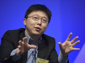 FILE - In this Dec. 1, 2015 file photo, Feng Zhang of the Broad Institute of MIT participates in a panel discussion at the National Academy of Sciences international summit on the safety and ethics of human gene editing, in Washington. Scientists are altering a powerful gene-editing technology in hopes of one day fighting diseases without making permanent changes to people's DNA.  (AP Photo/Susan Walsh)