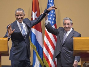 FILE - In this March 21, 2016 file photo, Cuban President Raul Castro, right, lifts up the arm of U.S. President Barack Obama, at the conclusion of their joint news conference at the Palace of the Revolution, in Havana, Cuba. The United States will vote this week against an annual United Nations resolution condemning the U.S. embargo on Cuba, reversing the Obama administration's abstention last year.  (AP Photo/Ramon Espinosa, File)