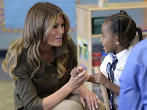 FILE - In this Sept. 15, 2017, file photo, first lady Melania Trump visits with children at a youth center at Andrews Air Force Base, Md. Melania Trump appears to becoming more at ease with her role as first lady. She is beginning to speak out more about how she envisions using her platform to help children in ways beyond cyberbullying.  (AP Photo/Susan Walsh, File)