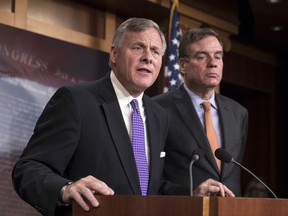 FILE - In this Oct. 4, 2017, file photo, Senate Select Committee on Intelligence Chairman Richard Burr, R-N.C., left, and Vice Chairman Mark Warner, D-Va., update reporters on the status of their inquiry into Russian interference in the 2016 U.S. elections, at the Capitol in Washington. As congressional investigations into Russian interference in the 2016 elections wear on in the Capitol, some lawmakers are starting to wonder when _ and how _ the probes will end. (AP Photo/J. Scott Applewhite, File)