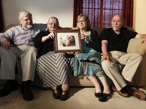 In this June 4, 2014, file photo, from left, Patrick Boyle, Linda Boyle, Lyn Coleman and Jim Coleman hold photo of their kidnapped children, Joshua Boyle and Caitlan Coleman, who were kidnapped by the Taliban in late 2012, Wednesday, June 4, 2014, in Stewartstown, Pa.