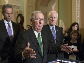 In this Oct. 17, 2017, photo, Senate Majority Leader Mitch McConnell, R-Ky., flanked by Sen. John Thune, R-S.D., left, and Majority Whip John Cornyn, R-Texas, announces to reporters that the Senate is moving ahead on a Republican budget plan at the Capitol in Washington. Senate Republicans seem to be on cruise control to pass a $4 trillion budget plan that shelves GOP deficit concerns in favor of the party's drive to cut taxes. (AP Photo/J. Scott Applewhite)