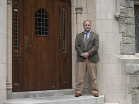 In this Sept. 20, 2017, photo, Peter Kochenburger, deputy director of the Insurance Law Center at the University of Connecticut School of law, poses for a portrait on the campus in Hartford, Conn. Kochenburger has been reviewing and evaluating insurance offered by the National Rifle Association to gun owners for protection in cases they shoot someone in what they consider to be self-defense. (AP Photo/Lisa Marie Pane)