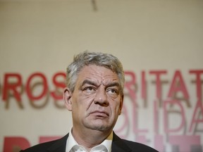 Romanian Prime Minister Mihai Tudose, speaks during a press conference, following a six-hour meeting of the ruling Social Democratic Party in Bucharest, Romania, Thursday, Oct. 12, 2017.  The prime minister says two ministers named in a land transfer criminal inquiry have resigned after weeks of tensions, signalling a victory for the country's anti-corruption fight. (AP Photo/Andreea Alexandru)