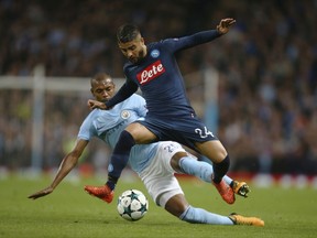 Napoli's Lorenzo Insigne, right, challenges for the ball with Manchester City's Fernandinho during the Champions League group F soccer match between Manchester City and Napoli at the Etihad Stadium in Manchester, England, Tuesday, Oct.17, 2017. (AP Photo/Dave Thompson)