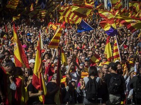 Nationalist activists march with Catalan, Spanish and European Union flags during a mass rally against Catalonia's declaration of independence, in Barcelona, Spain, Sunday, Oct. 29, 2017. Thousands of opponents of independence for Catalonia held the rally on one of the city's main avenues after one of the country's most tumultuous days in decades. (AP Photo/Santi Palacios)