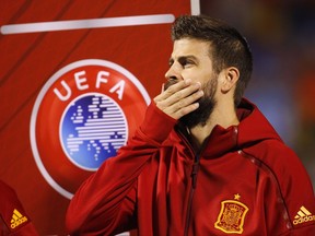 Spain's Gerard Pique stands with his teammates before the World Cup Group G qualifying soccer match between Spain and Albania at the Rico Perez stadium in Alicante, Spain, Friday, Oct. 6, 2017. Spain coach Julen Lopetegui has defended Gerard Pique from critics who question his loyalty to the national team because of his support for a disputed referendum on Catalan independence. (AP Photo/Alberto Saiz)