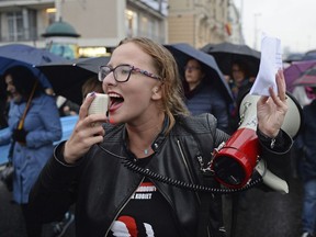 Women shout slogans as they march through the downtown in a protest against efforts by the nation's conservative leaders to tighten Poland's already restrictive abortion law in Warsaw, Poland, Tuesday, Oct. 3, 2017. (AP Photo/Alik Keplicz)