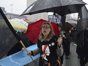 FILE In this Oct. 3, 2017 file photo women shout slogans as they march downtown in a protest against efforts by the nation's conservative leaders to tighten Poland's already restrictive abortion law, in Warsaw, Poland. Poland's president has signed into law a divisive bill on funding for non-governmental organizations that critics say the conservative government may use to undercut groups it does not approve of. (AP Photo/Alik Keplicz, file)