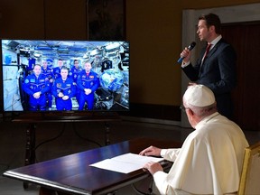 Pope Francis connects to the crew aboard the International Space Station from the Vatican, Thursday, Oct. 26, 2017. Pope Francis' hookup Thursday will mark the second papal phone call to space: Pope Benedict XVI rang the space station in 2011, and peppered its residents with questions about the future of the planet and the environmental risks it faced. (L'Osservatore Romano/Pool Photo via AP)