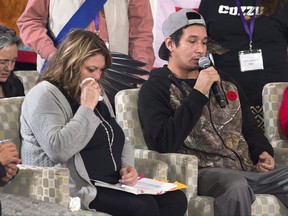 Cheryl Maloney, left, an advocate for the family of Victoria Rose Paul from Indian Brook, N.S. who died in 2009 after suffering a stroke while in jail for public intoxication, listens as Paul's son Deveron Paul speaks at the National Inquiry into Missing and Murdered Indigenous Women and Girls, in Membertou, N.S. on Tuesday, Oct. 31, 2017. THE CANADIAN PRESS/Andrew Vaughan