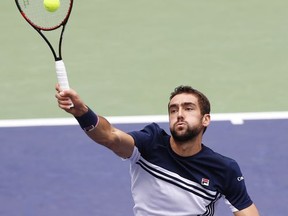 Marin Cilic of Croatia hits a return shot against Albert Ramos-Vinolas of Spain during their men's quarterfinals match in the Shanghai Masters tennis tournament at Qizhong Forest Sports City Tennis Center in Shanghai, China, Friday, Oct. 13, 2017. (AP Photo/Andy Wong)