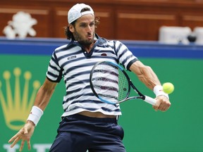 Feliciano Lopez of Spain returns a shot against Ivo Karlovic of Croatia during their men's singles match of the Shanghai Masters tennis tournament at Qizhong Forest Sports City Tennis Center in Shanghai, China, Monday, Oct. 9, 2017. (AP Photo/Andy Wong)