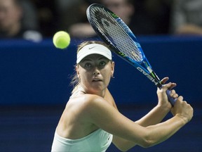 Russia's Maria Sharapova plays a return during the first round match against Slovakia's Magdalena Rybarikova at the Kremlin Cup tennis tournament in Moscow, Russia, Tuesday, Oct. 17, 2017. Sharapova returned in April from a 15-month doping ban and won her first title of the season last week in Tianjin, China. (AP Photo/Alexander Zemlianichenko)
