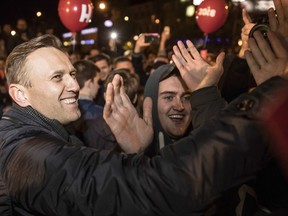Russian opposition leader Alexei Navalny, left, greets his supporters during a rally in Arkhangelsk, 1200 kilometers ( 750 miles) north of Moscow, Russia, Sunday, Oct. 1, 2017. Navalny, who announced his presidential bid last year, has organized a grassroots campaign in Russian regions to support his nomination. (Evgeny Feldman/Navalny Campaign via AP)