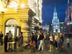 In this Wednesday, Sept. 13, 2017 file photo, people are checked by security guards before entering GUM, State Shop, at Red square in Moscow, Russia