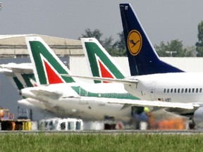 -FILE - In this April 23, 2008 file photo, Lufthansa and Alitalia jetliners are parked at the Milan Linate airport, Italy. The Italian daily Corriere della Sera says Lufthansa is preparing a 500 million-euro ($590 million) bid for large parts of bankrupt Italian carrier Alitalia, including the fleet, pilots, air crew and air slots. Alitalia, which declared bankruptcy in May, faces a Monday deadline for binding offers. (AP Photo/Antonio Calanni/Files)