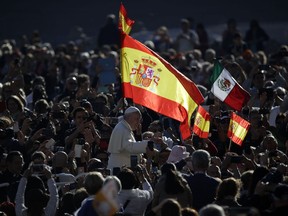 Pope Francis passes by a Spanish flags waving in the crowd during his weekly general audience, in St. Peter's Square, at the Vatican, Wednesday, Oct. 11, 2017. (AP Photo/Alessandra Tarantino)