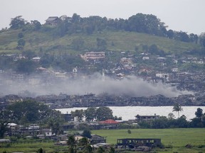Smoke rises over the city as explosions continue to reverberate in Marawi, a day after President Rodrigo Duterte declared its liberation in the southern Philippines, Wednesday, Oct. 18, 2017. Sporadic explosions and gunfire continue Wednesday as Philippine soldiers fought to gain control of the last pocket of Marawi controlled by Islamic militants. (AP Photo/Bullit Marquez)